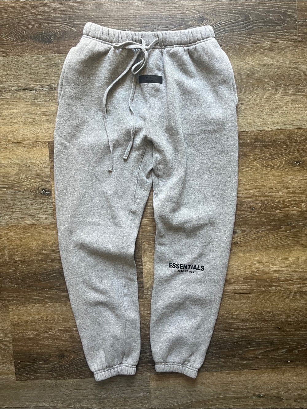 Fear of God Essentials joggers in a light grey color. Size medium